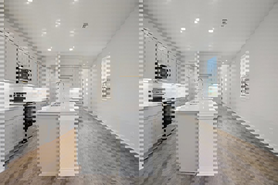 A kitchen with white cabinets.