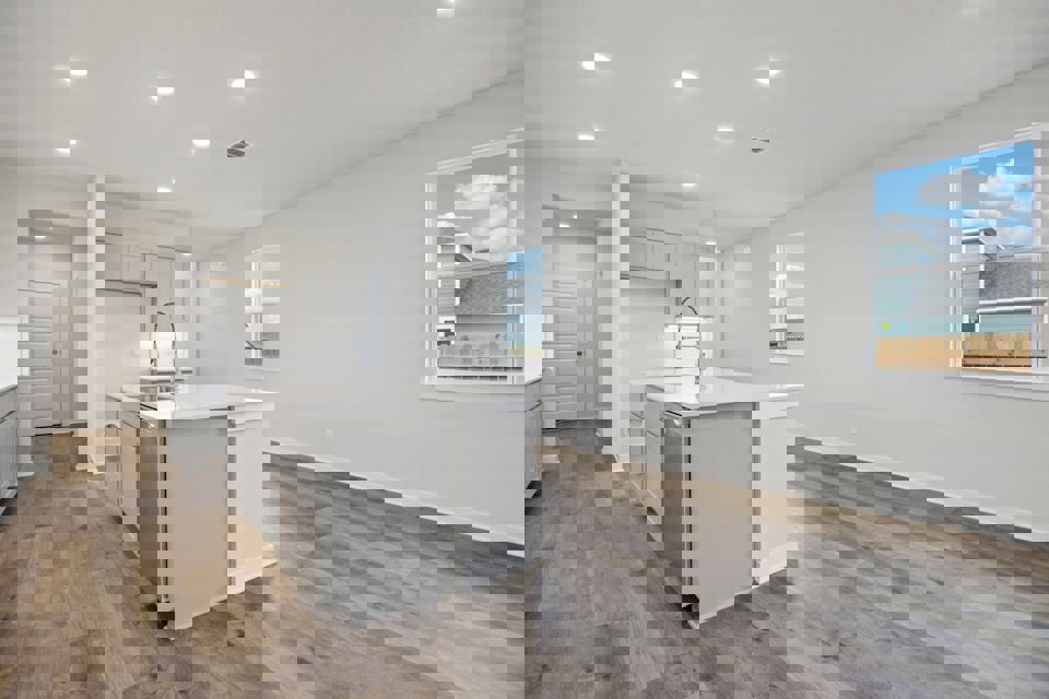 A kitchen with white cabinets.