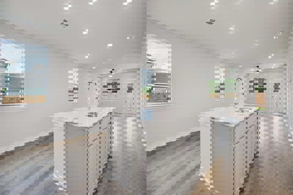 A kitchen with white cabinets.