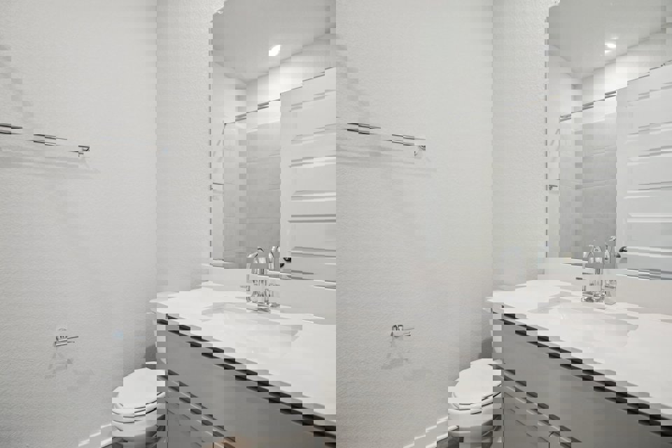 A bathroom with a sink and a toilet.