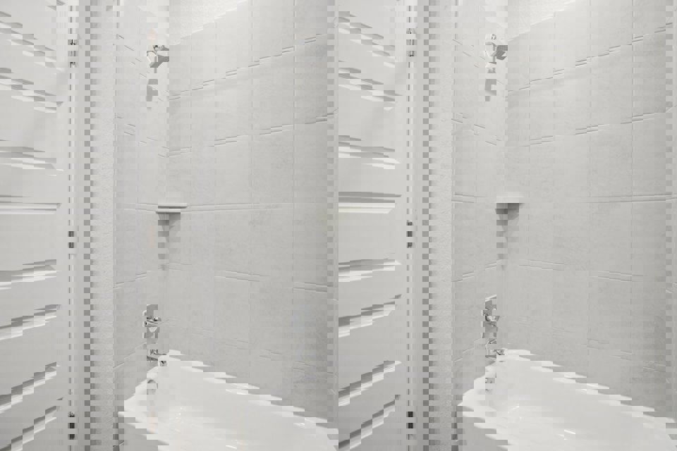 A bathtub in a bathroom.