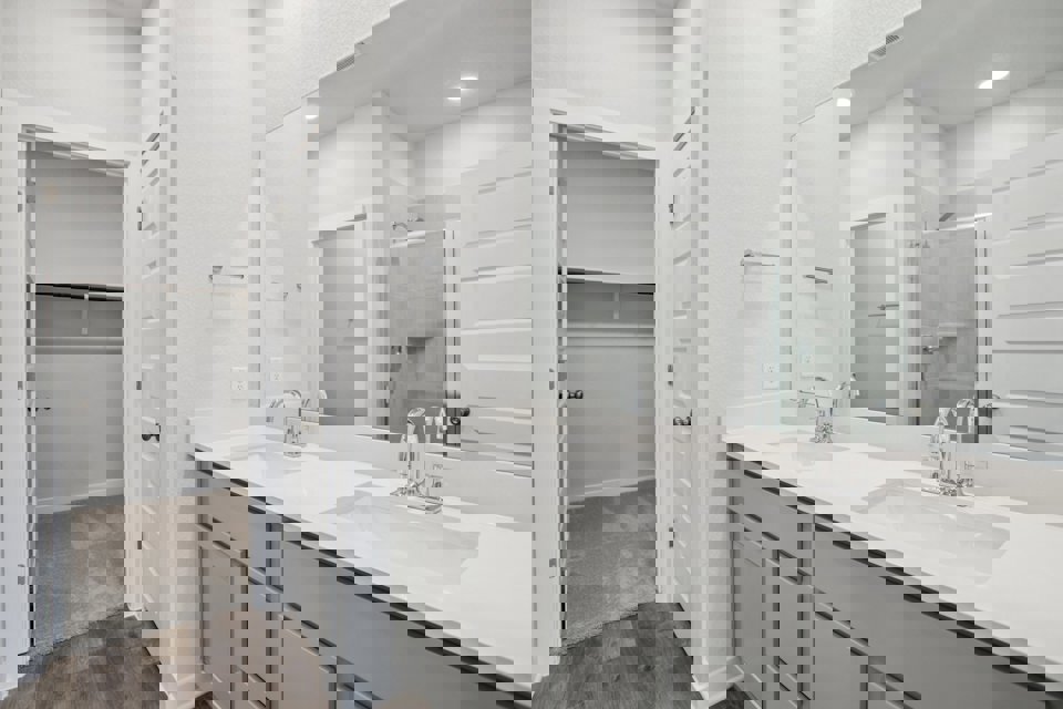 A bathroom with a large mirror.