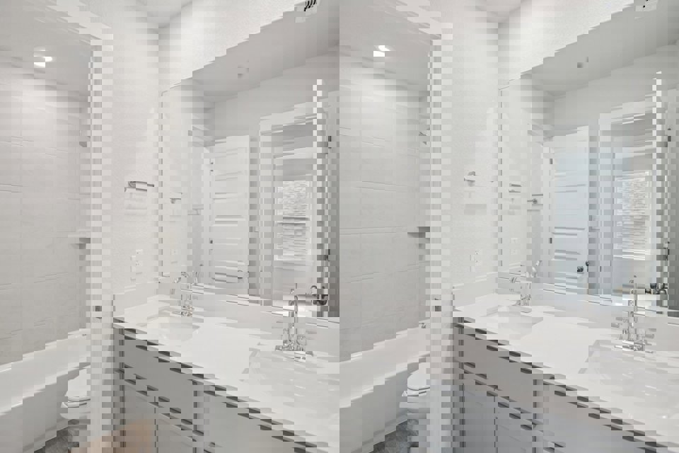 A bathroom with a large mirror.