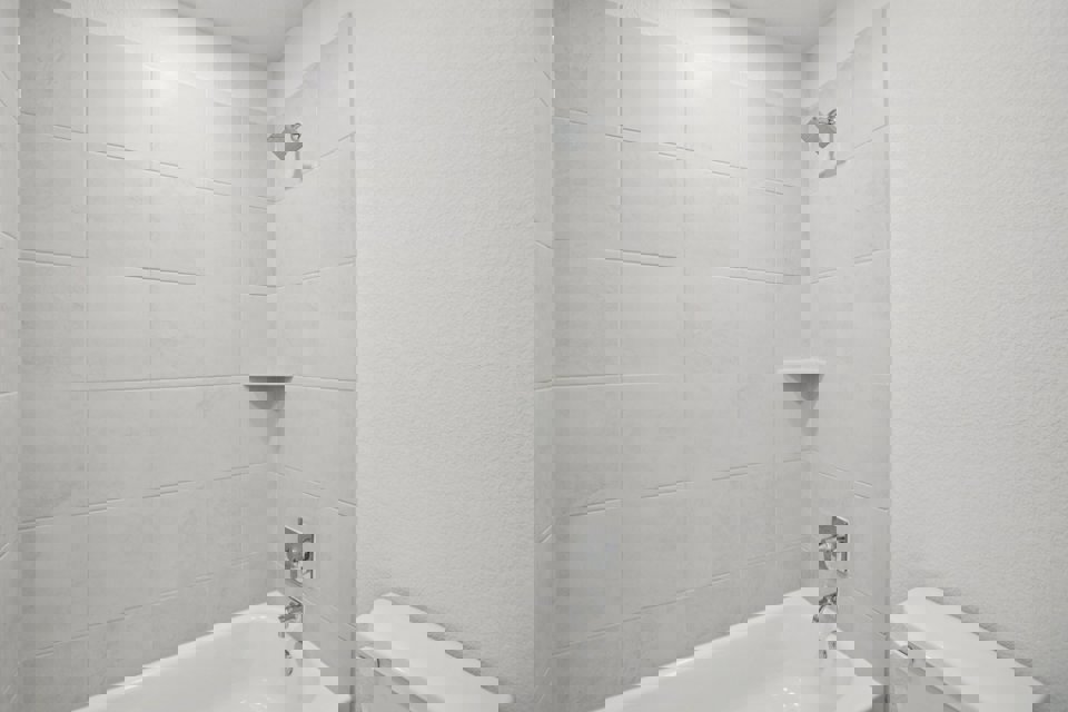 A bathroom with a bathtub and toilet.