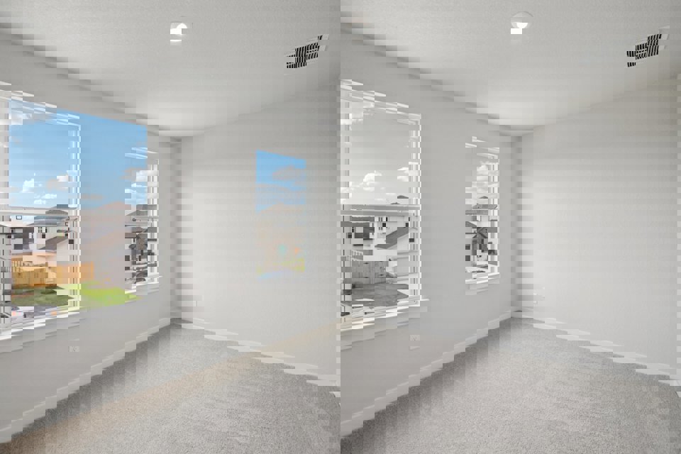 A room with a window and a painting on the wall.