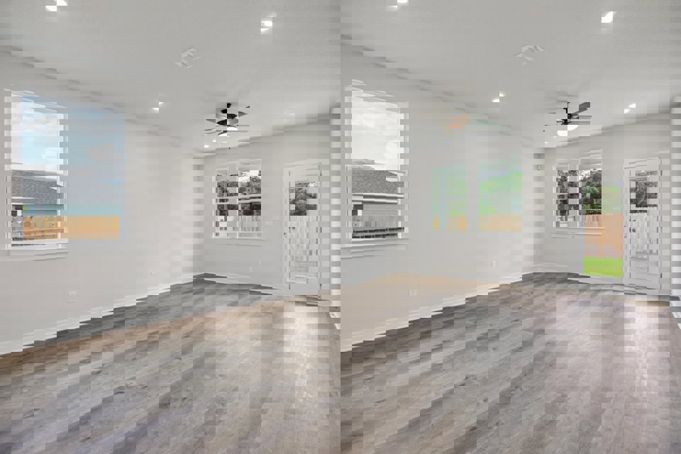 A room with a wood floor and a ceiling fan.