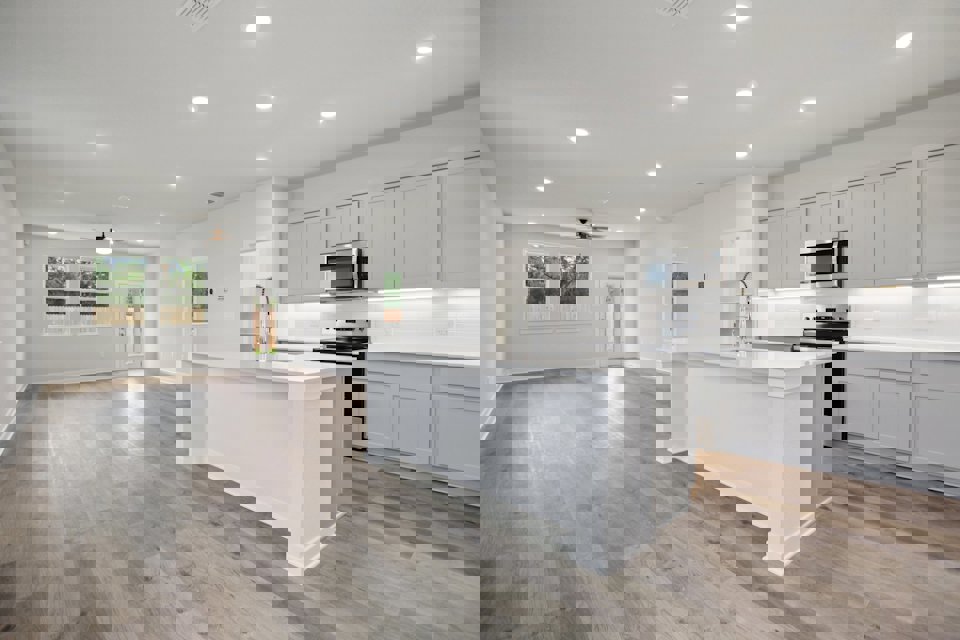 A kitchen with white cabinets.