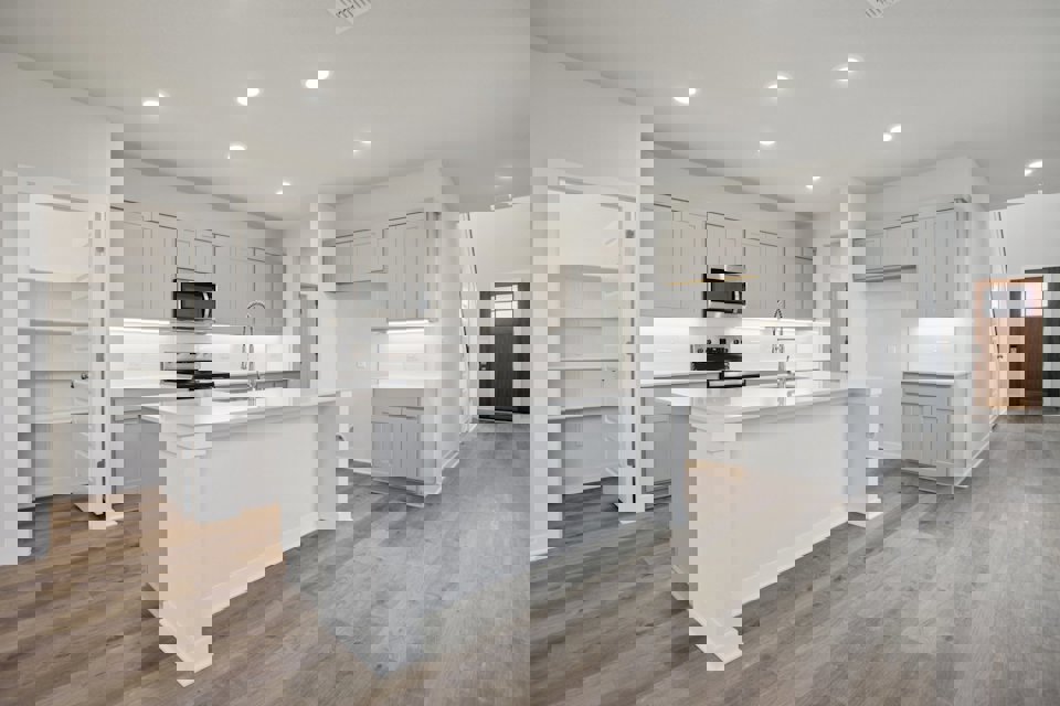 A kitchen with white cabinets.