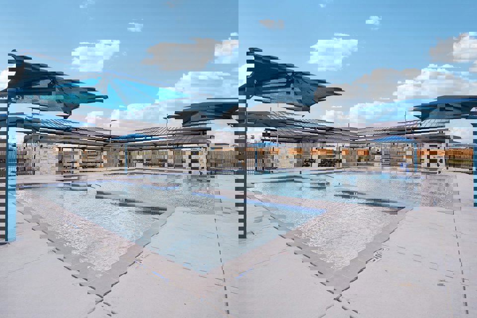 A swimming pool outside of a building.