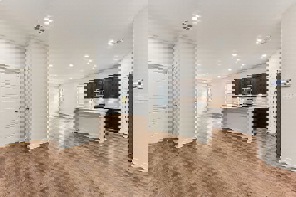 A kitchen with white cabinets.