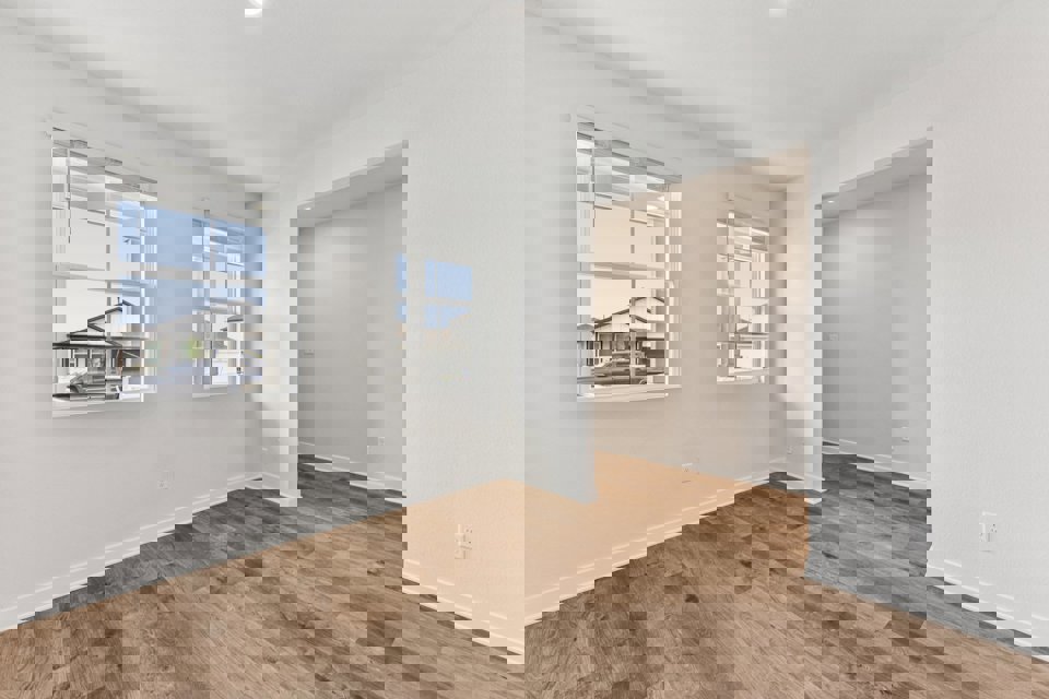 A room with a wood floor and a window.