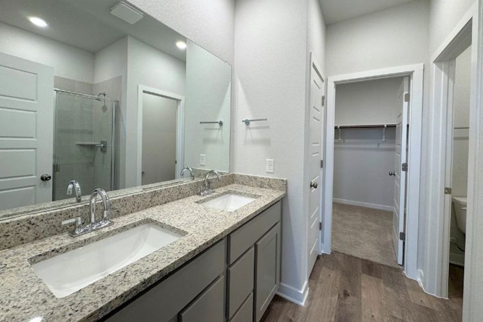 A bathroom with a large mirror.
