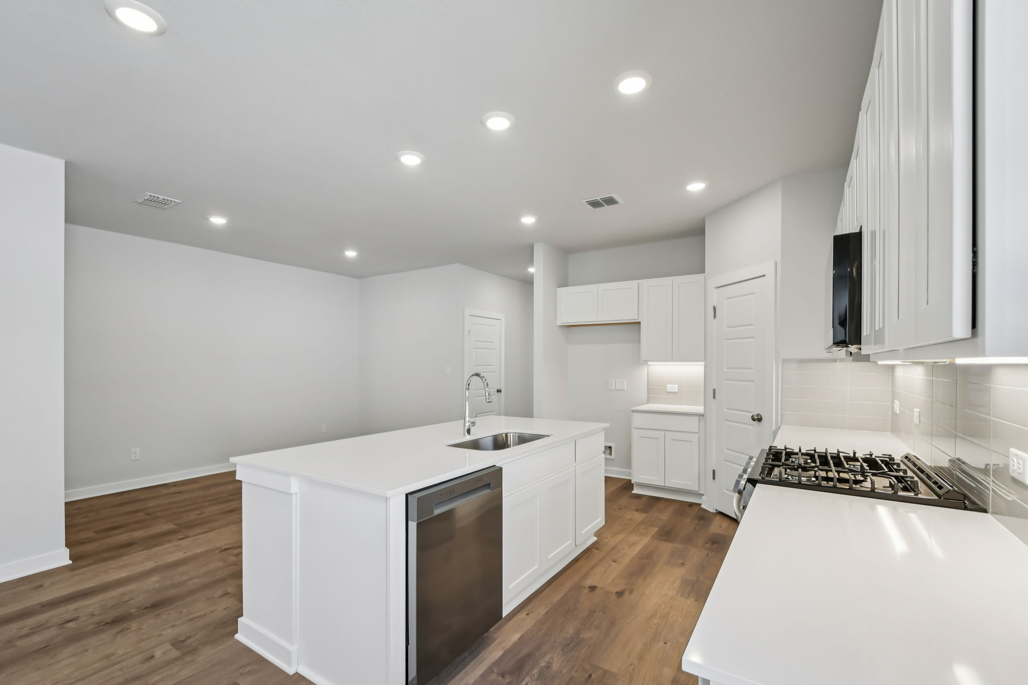 A kitchen with white cabinets.
