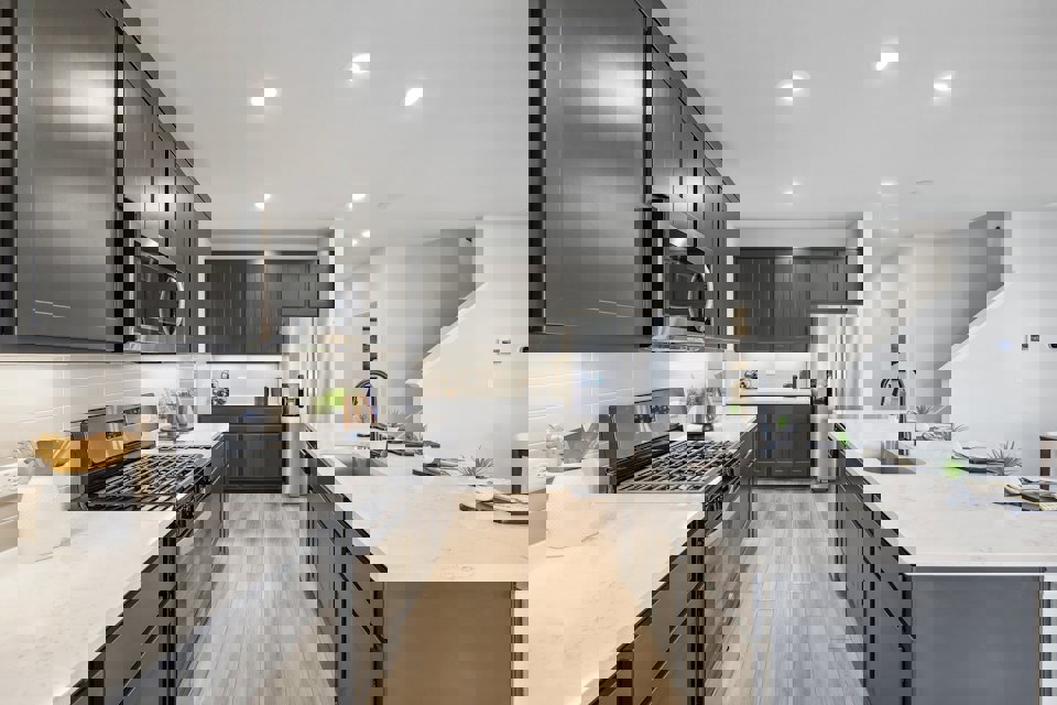 A kitchen with black cabinets.