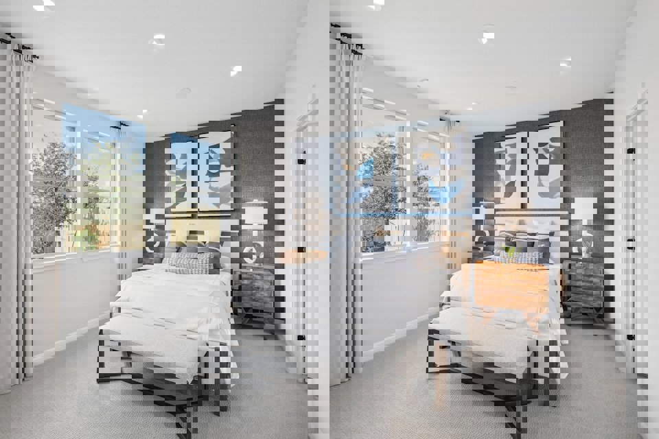 A bedroom with a bed and a bench.