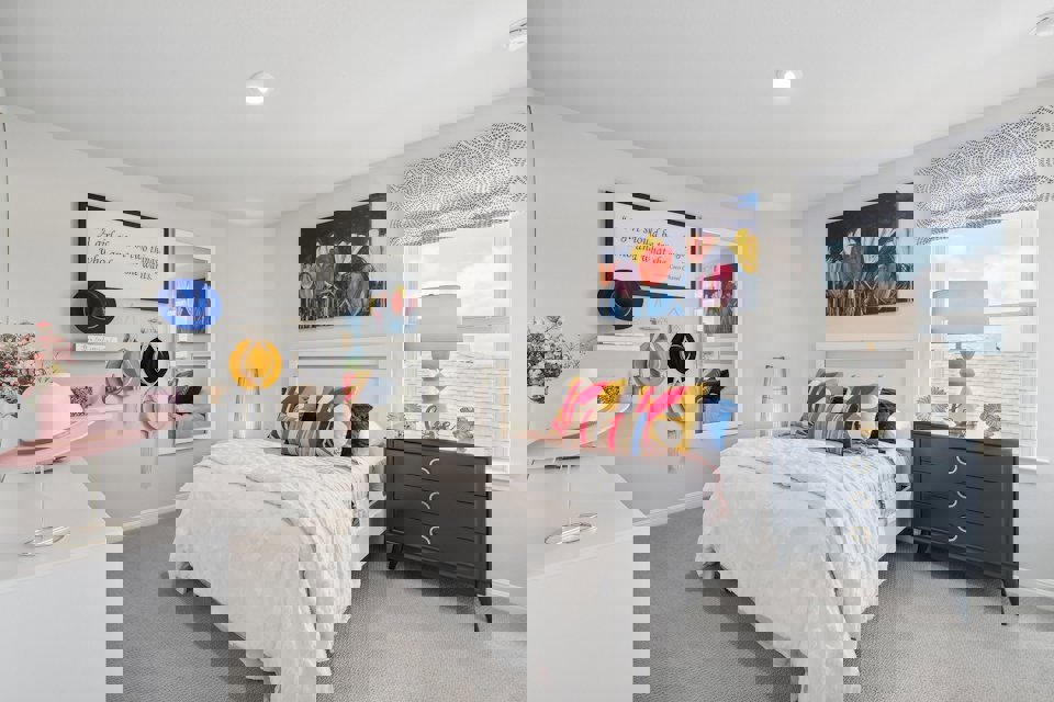 A bedroom with a bed and a dresser.