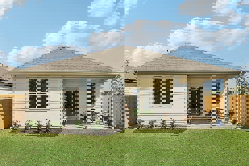 A person sitting in a chair outside a house.