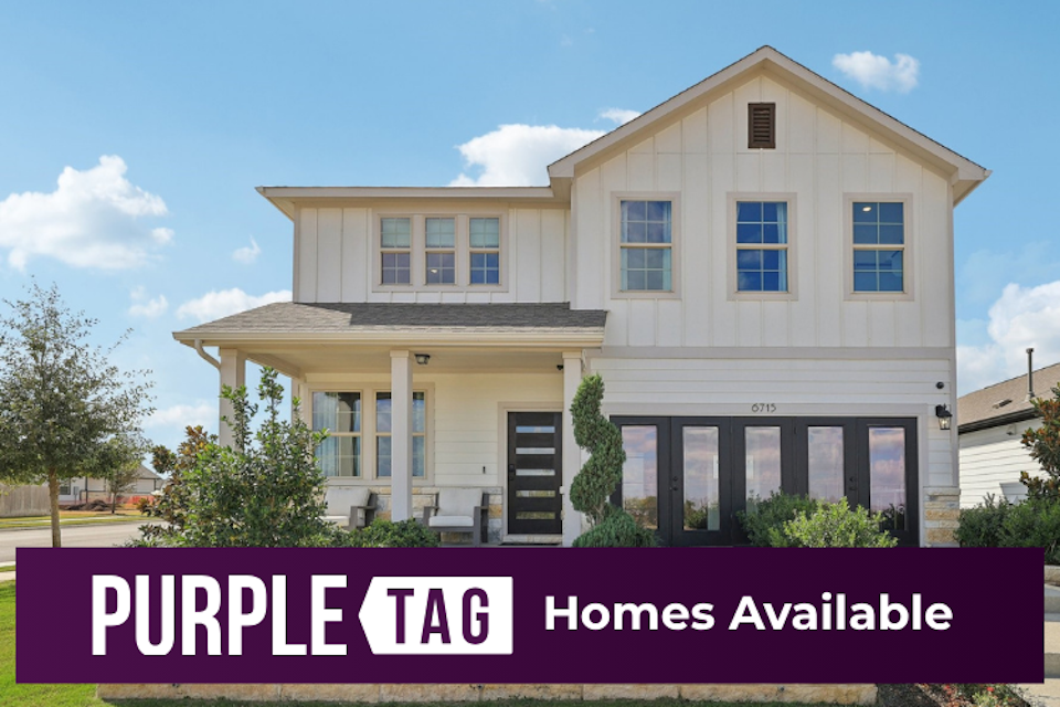 A white building with a sign in front of it.