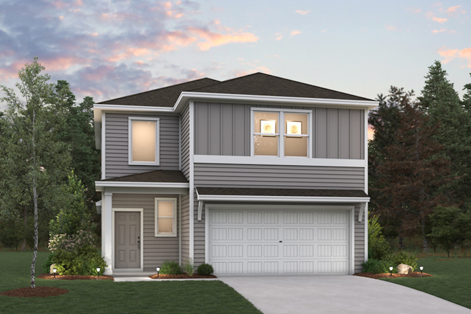 A house with a garage and trees.
