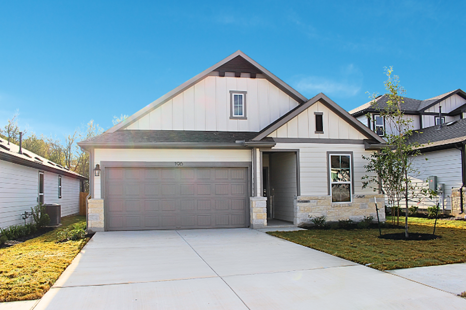 A house with a garage with American Gothic House in the background.