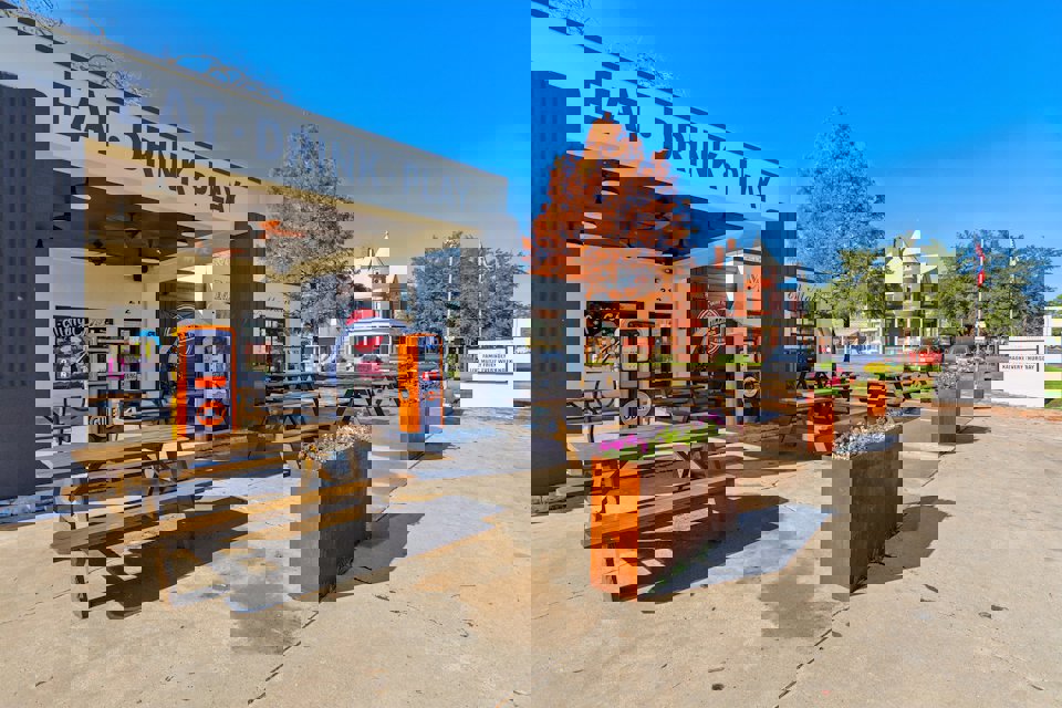 A store front with tables and benches.