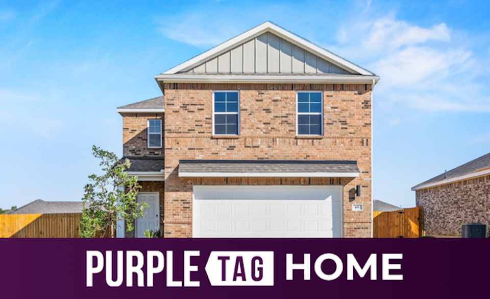 A brick building with a garage.