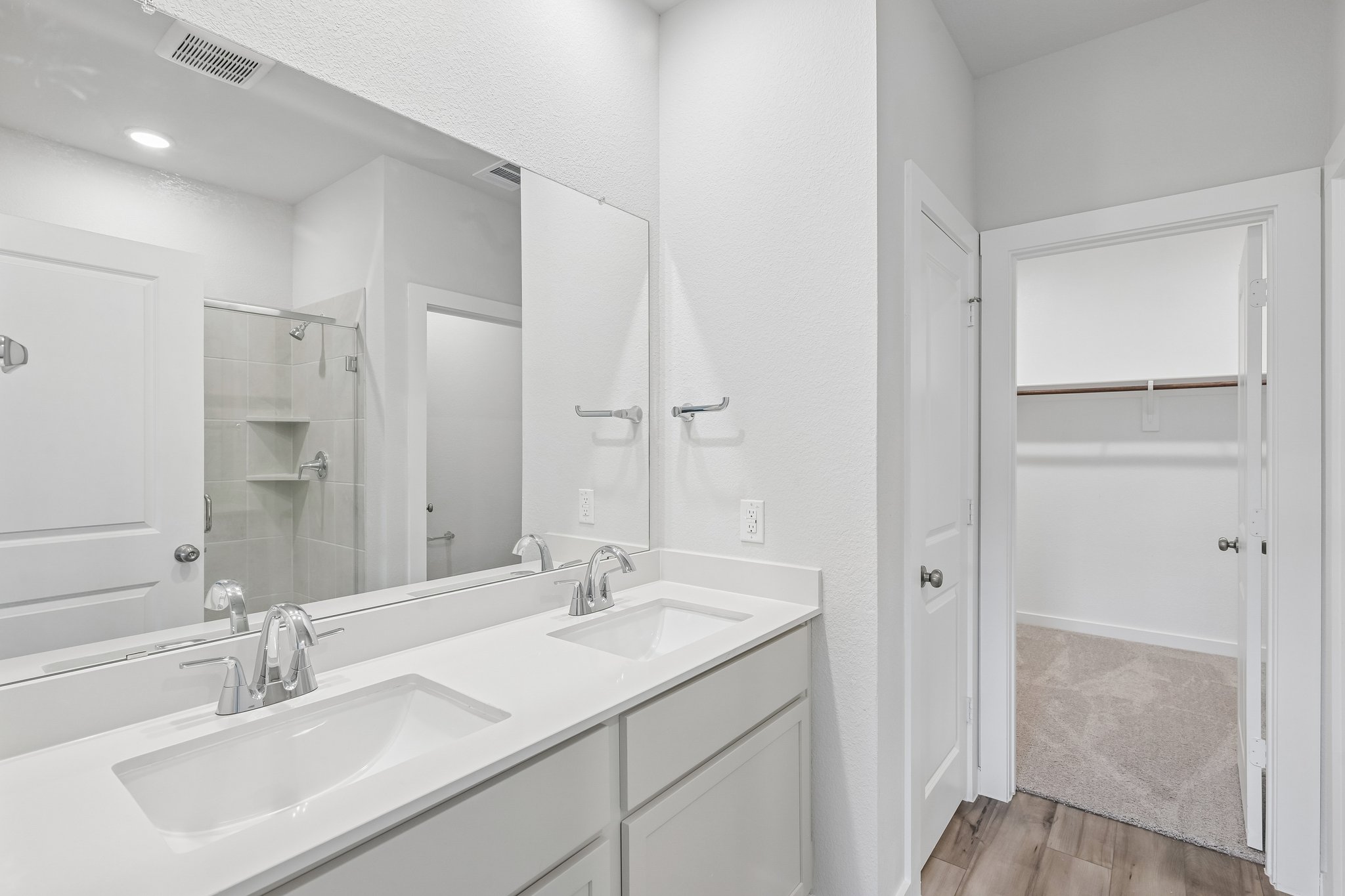 A bathroom with a large mirror.