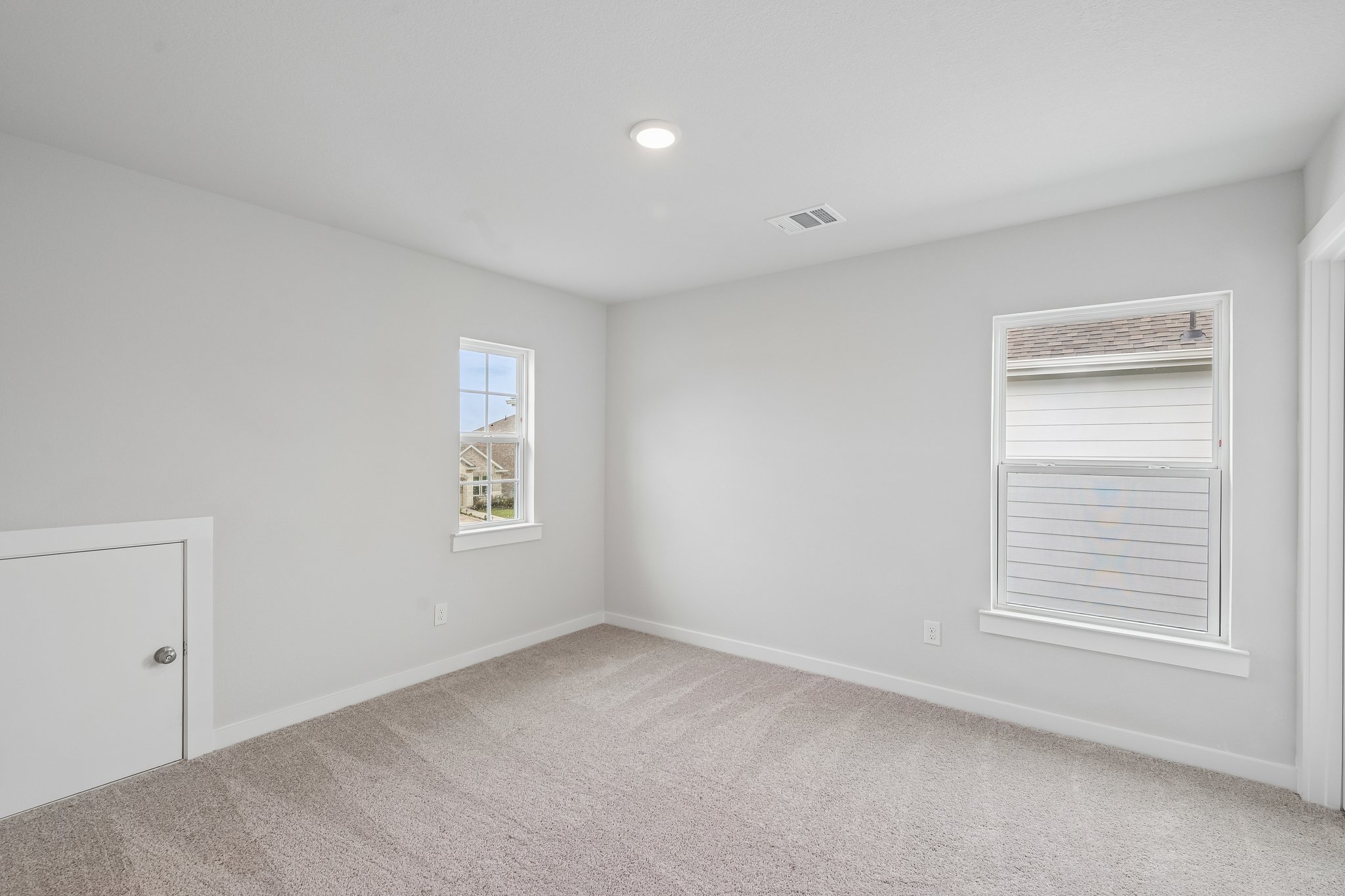A room with a window and a door.