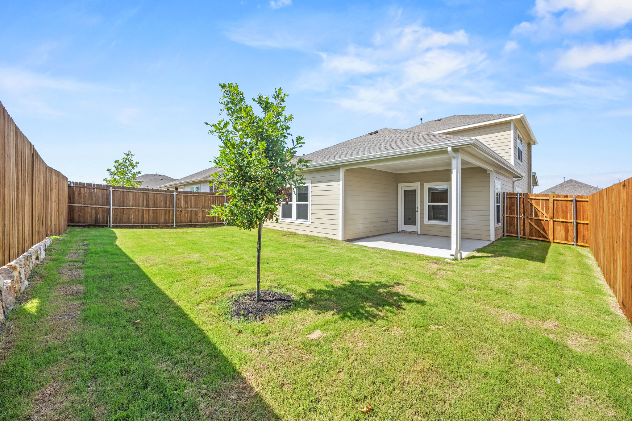 A house with a tree in the front yard.