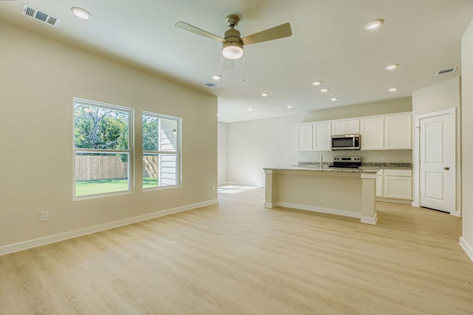 A large kitchen with white cabinets.