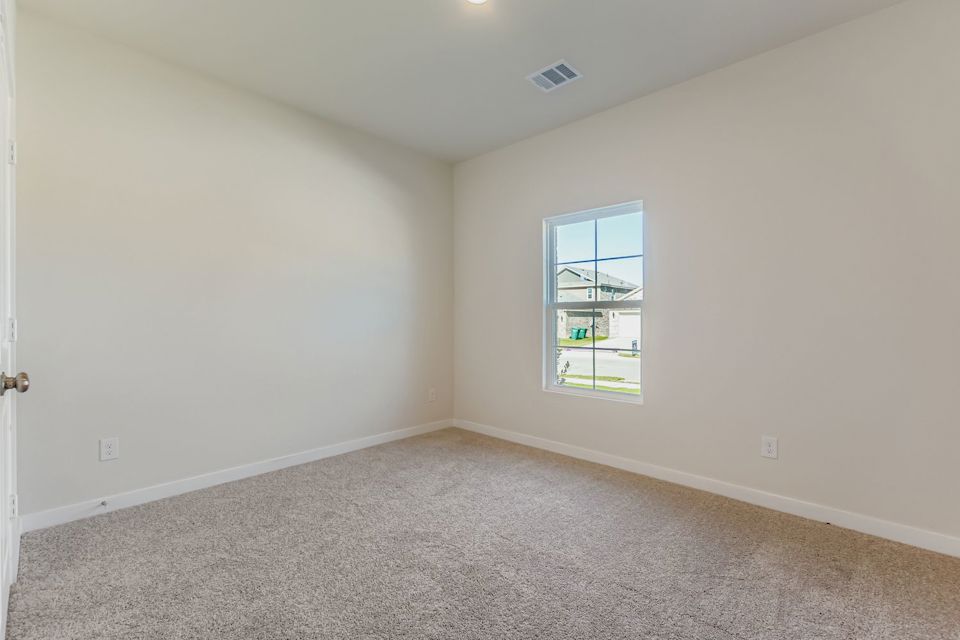 A room with a window and carpet.