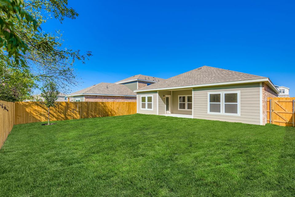 A house with a fence and grass.