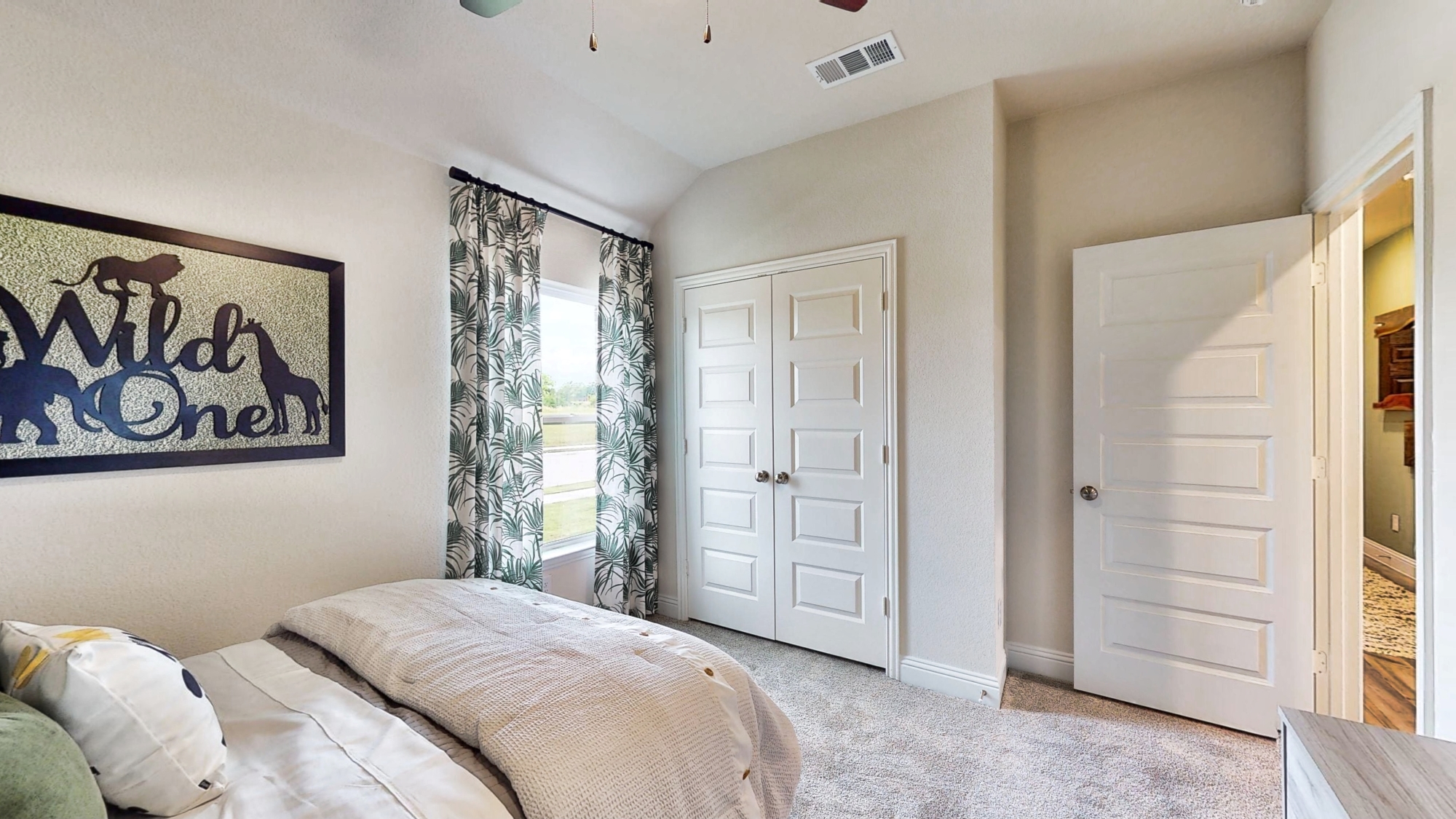 A bedroom with a bed and a window.