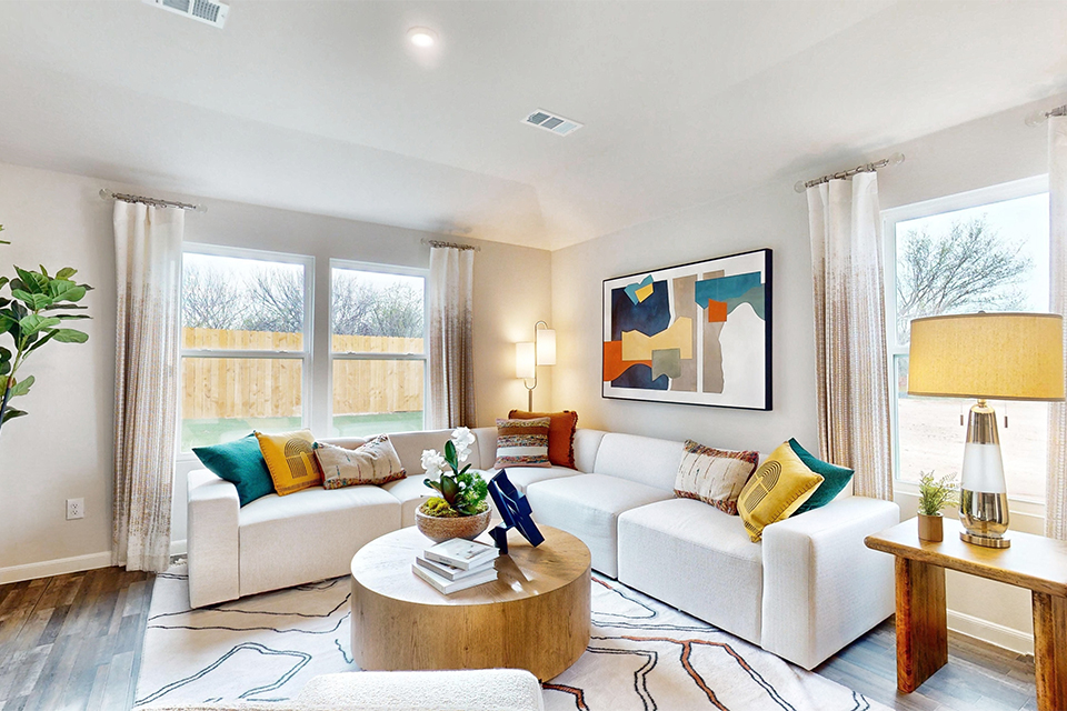 A living room with a white couch and a coffee table.