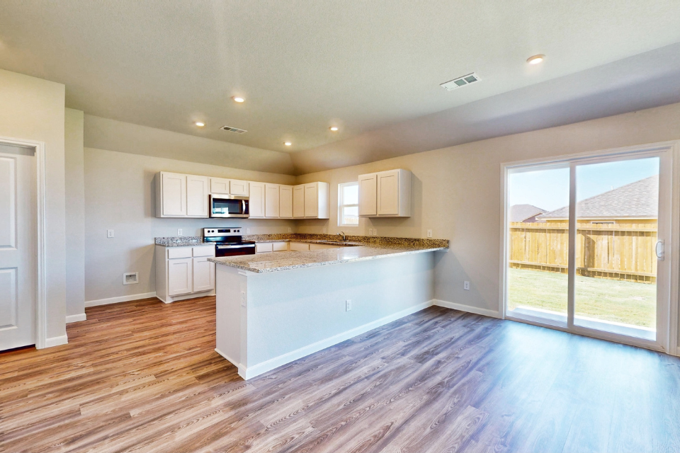 A kitchen with white cabinets.