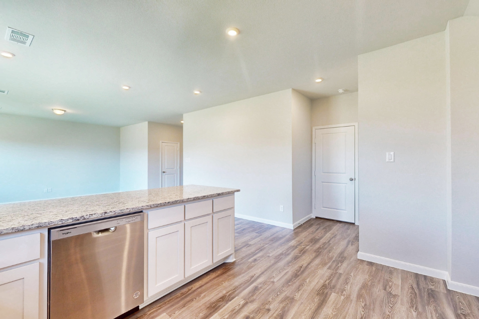 A kitchen with white cabinets.