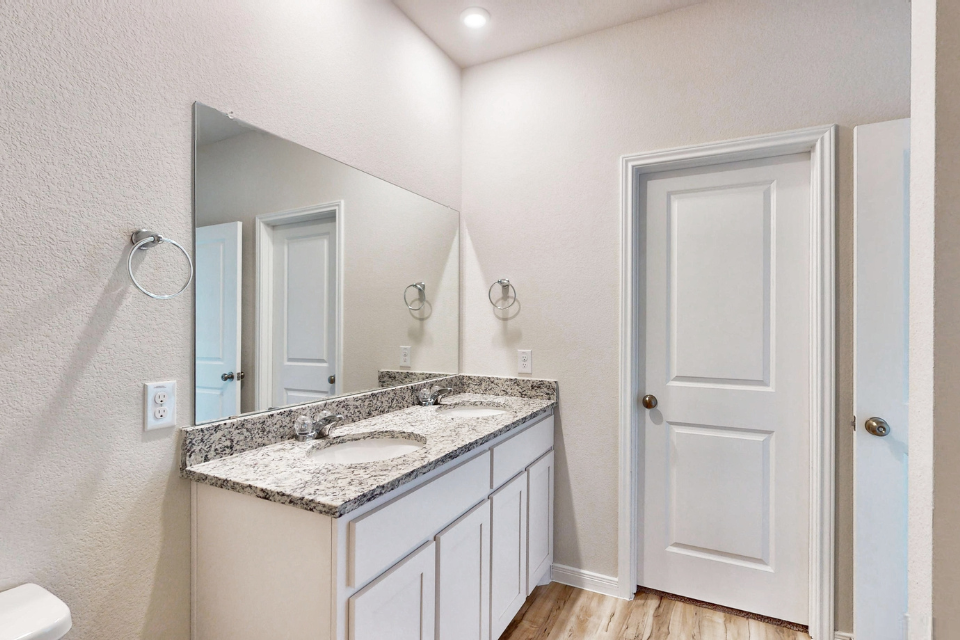 A bathroom with a marble countertop.