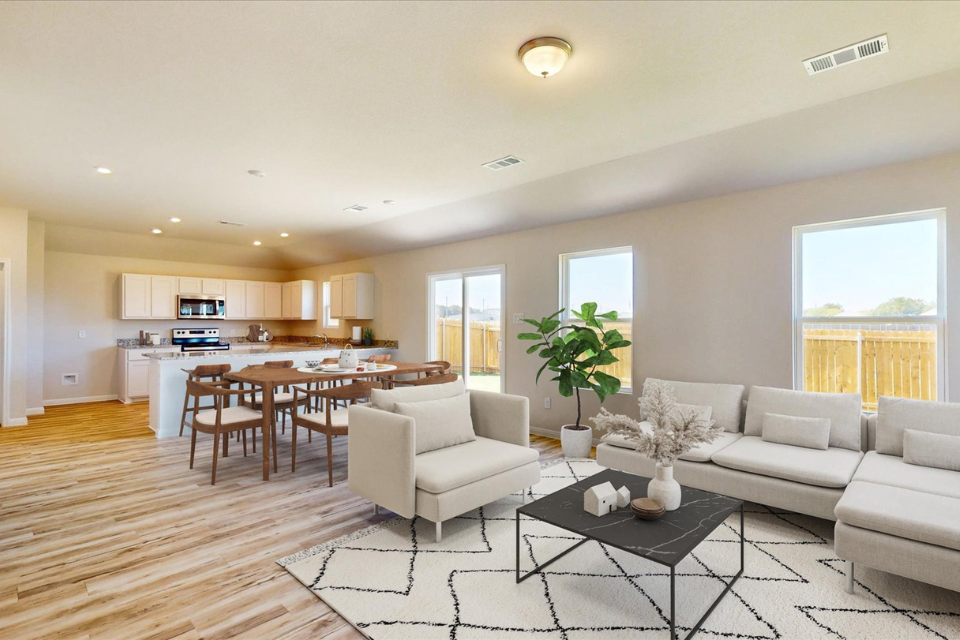A large living room with a dining table and couches.