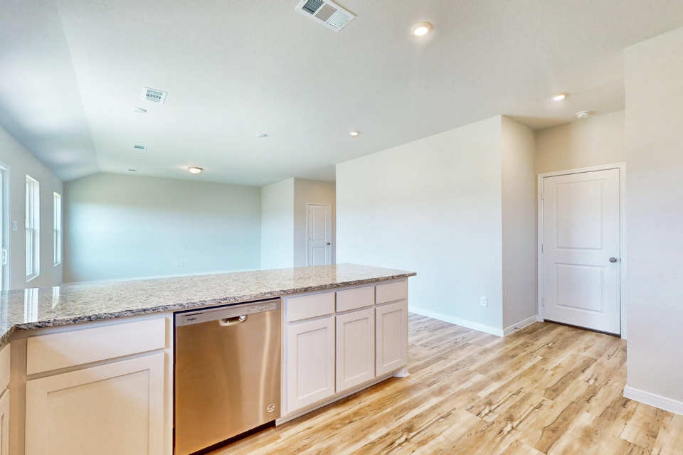 A kitchen with white cabinets.