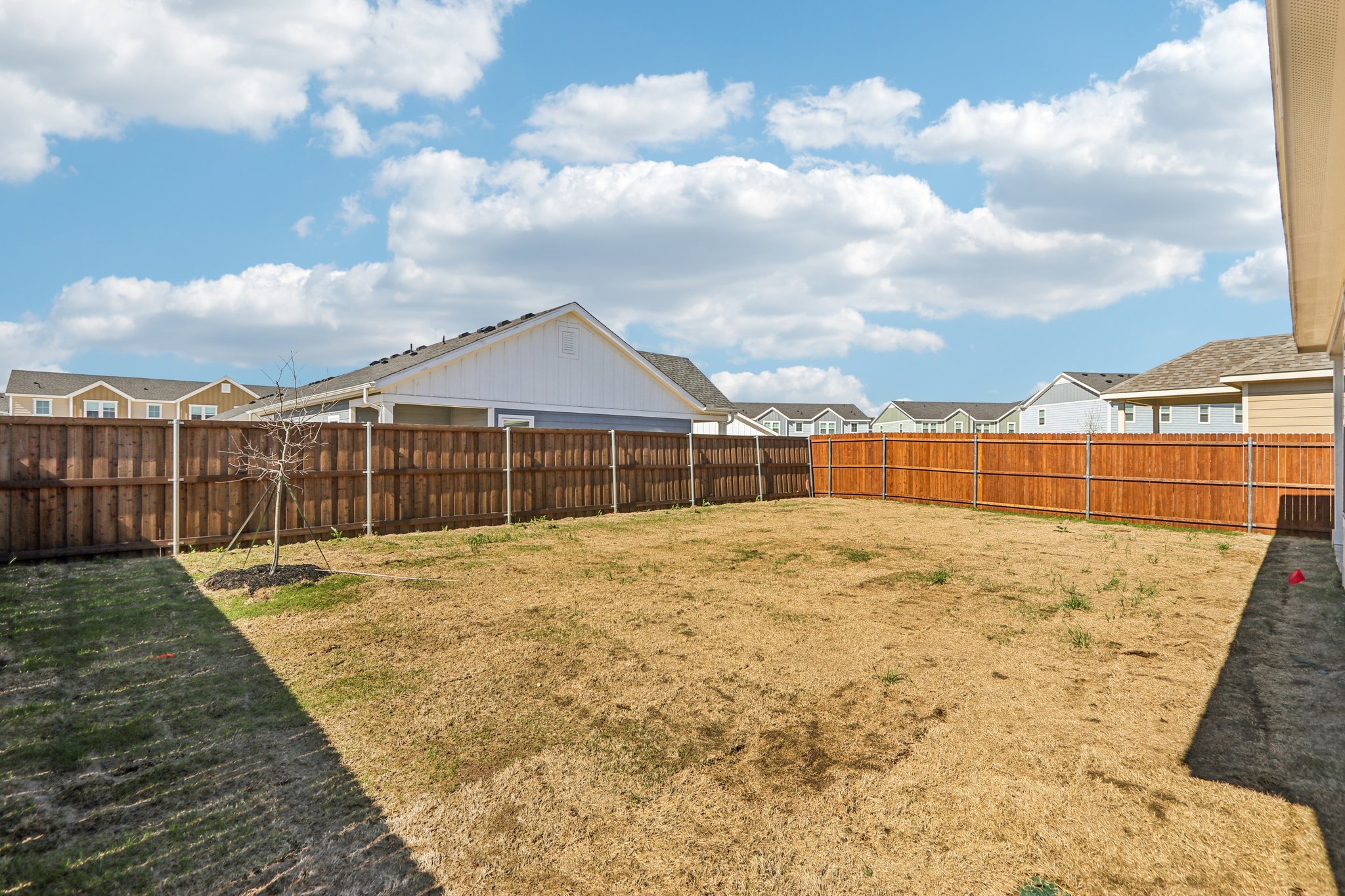 A fenced in area with a building in the background.