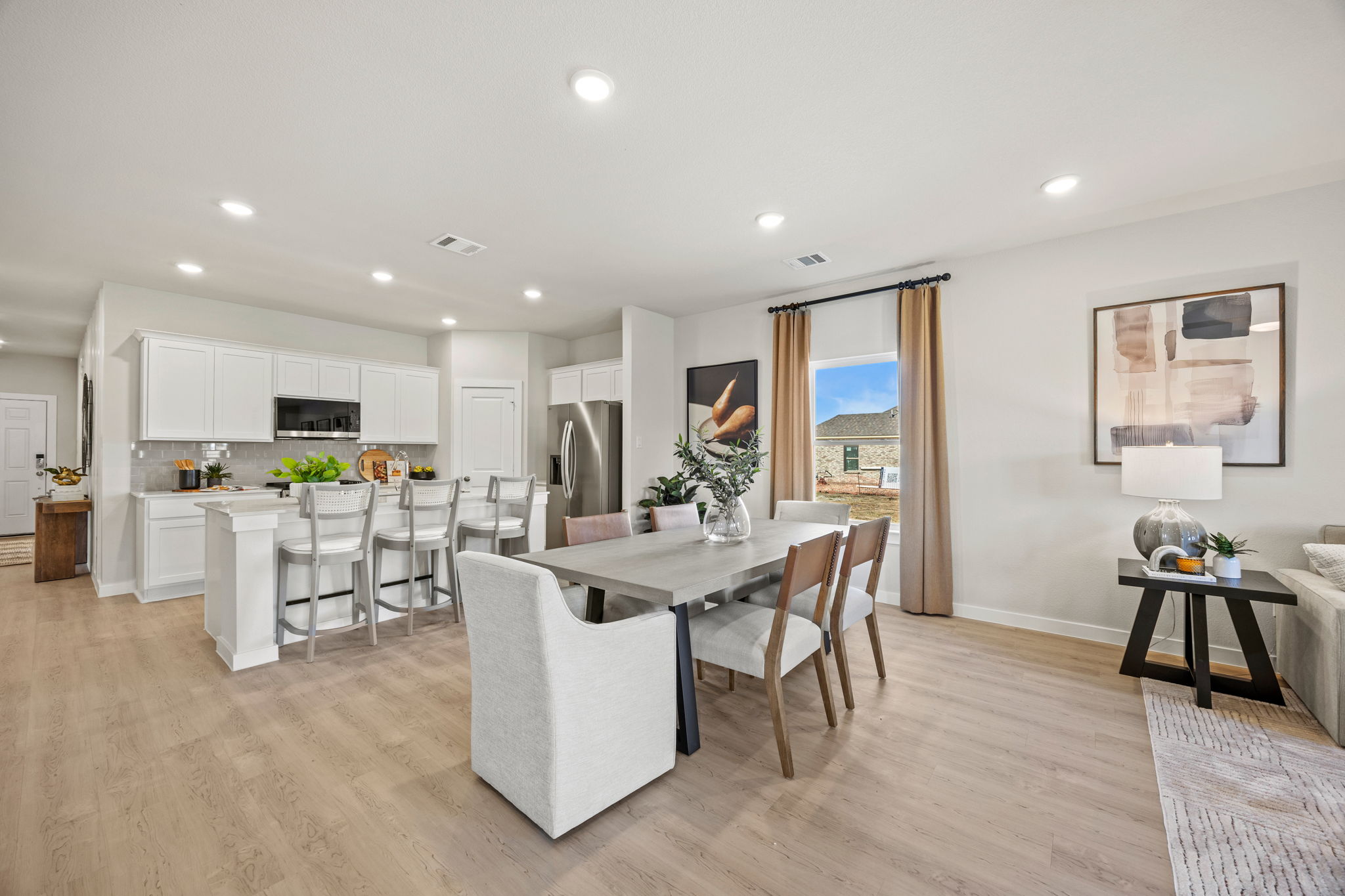 A large kitchen with a dining table.