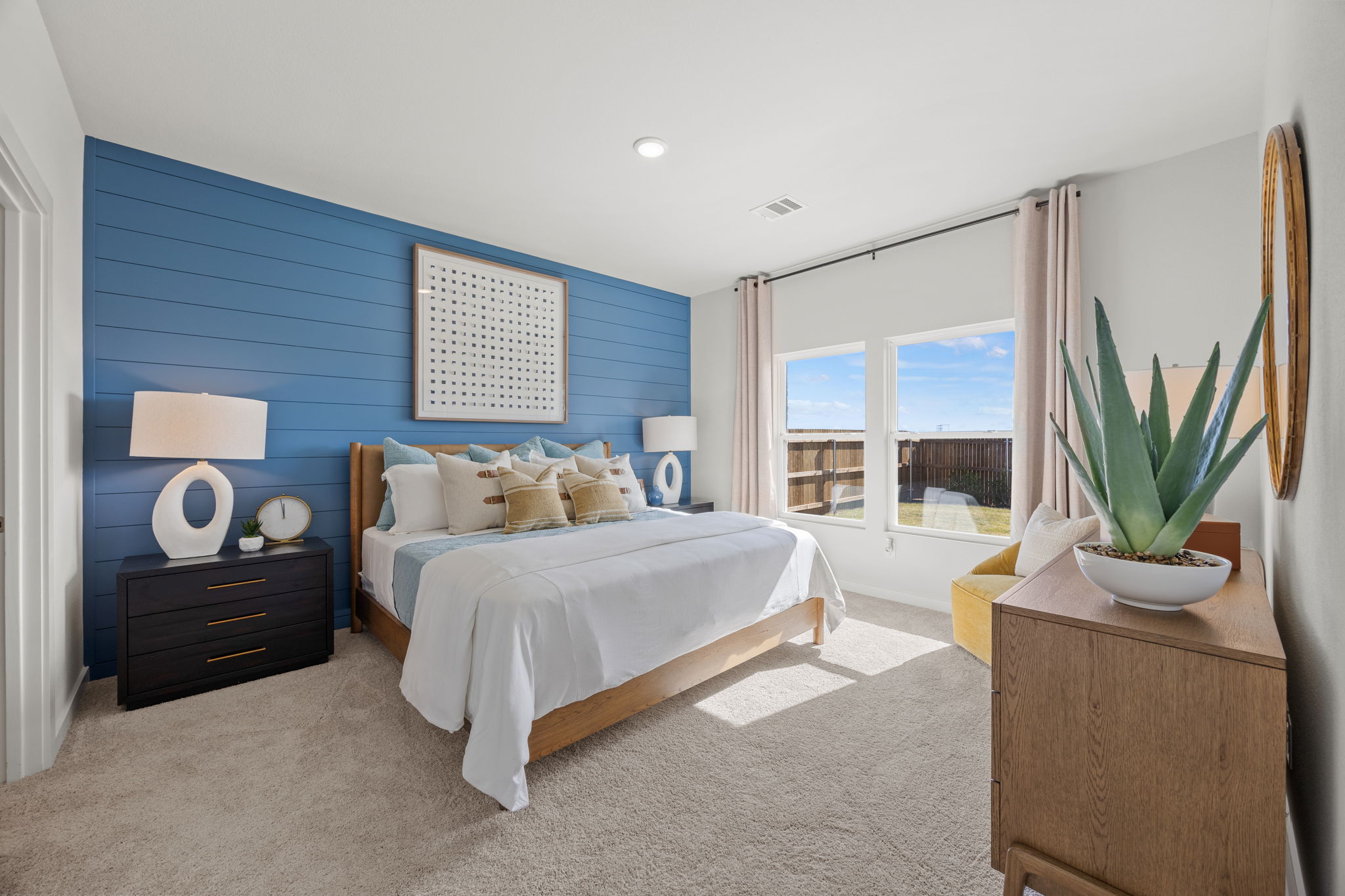 A bedroom with a bed and a table.