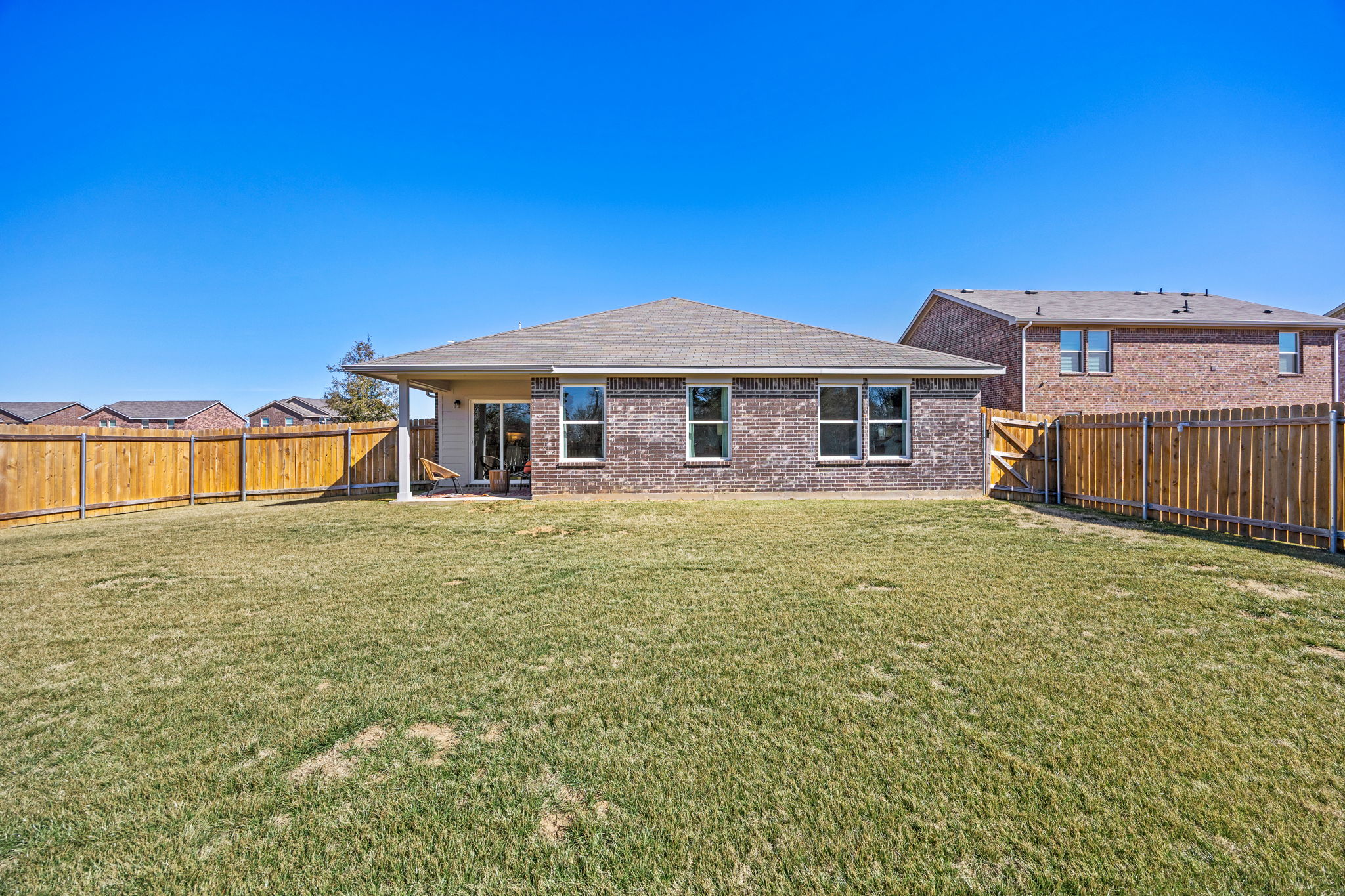 A house with a fence and grass.