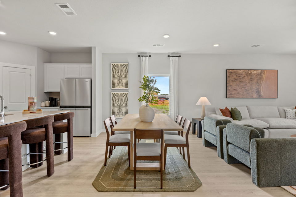 A large living room with a dining table and chairs.
