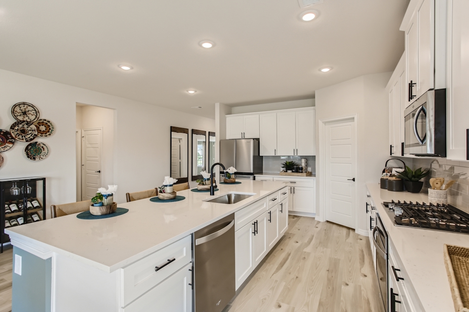 A kitchen with white cabinets.