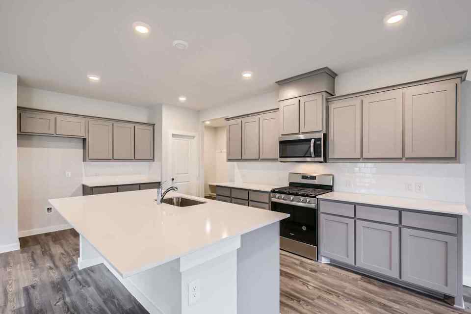 A kitchen with white cabinets.