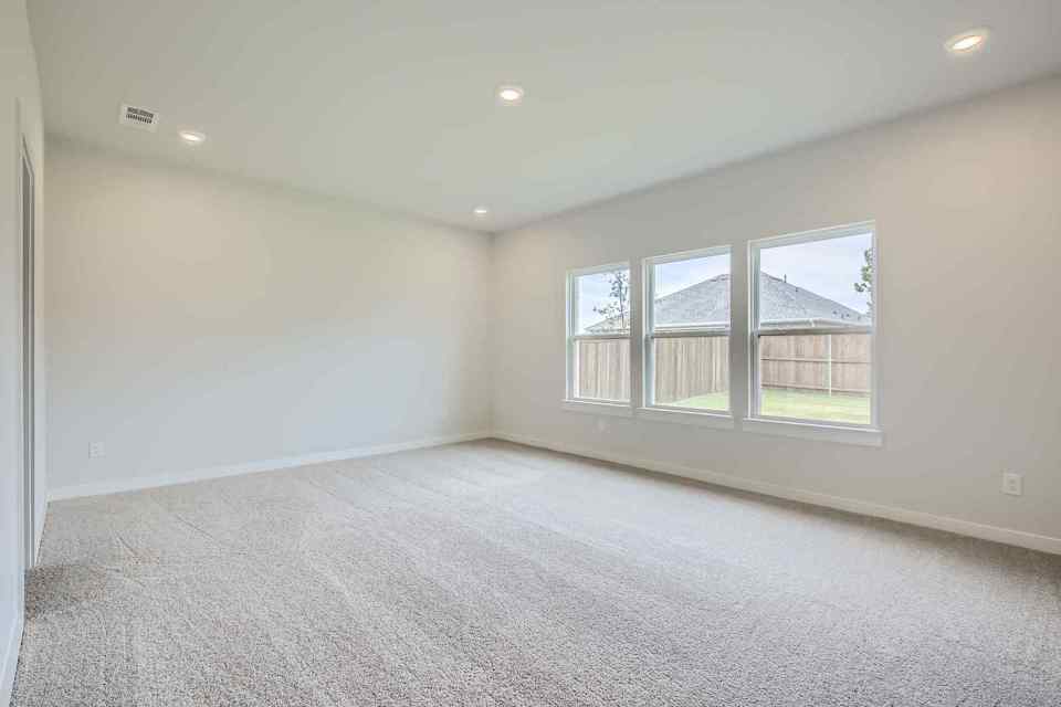 A room with a window and a carpet.