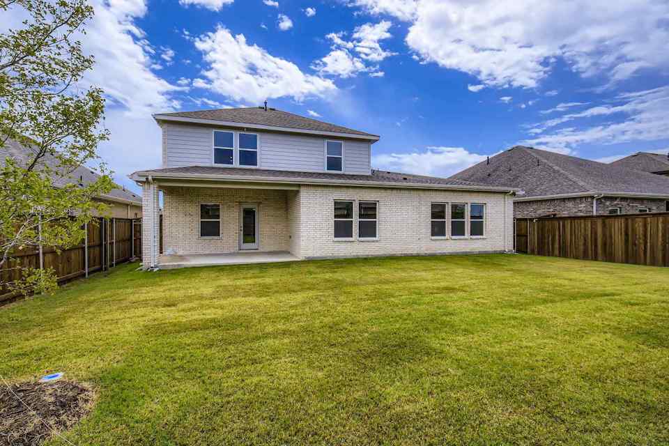 A house with a fence and grass.