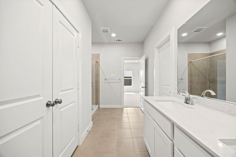A bathroom with white cabinets.