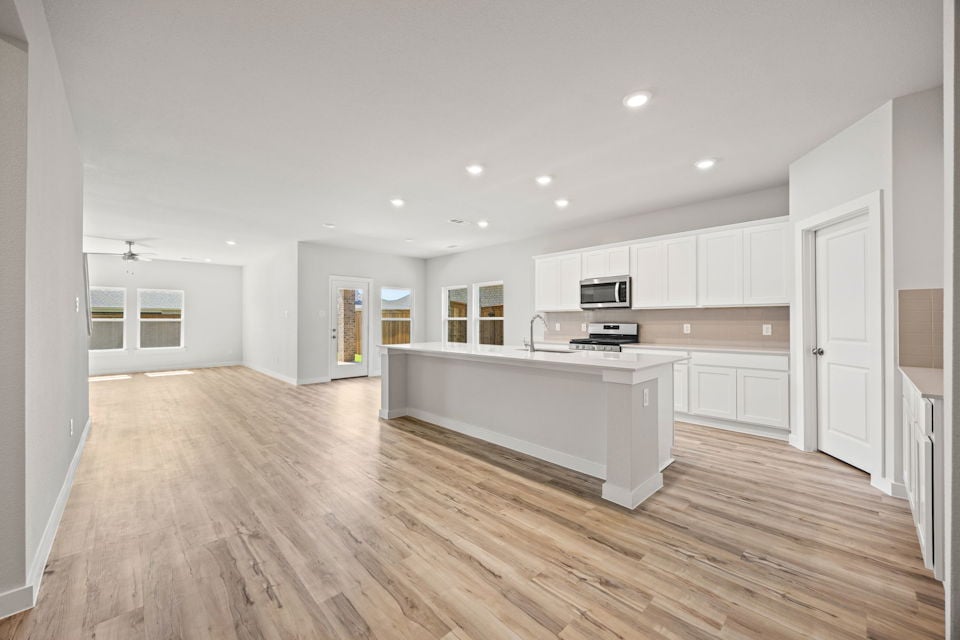 A large kitchen with white cabinets.